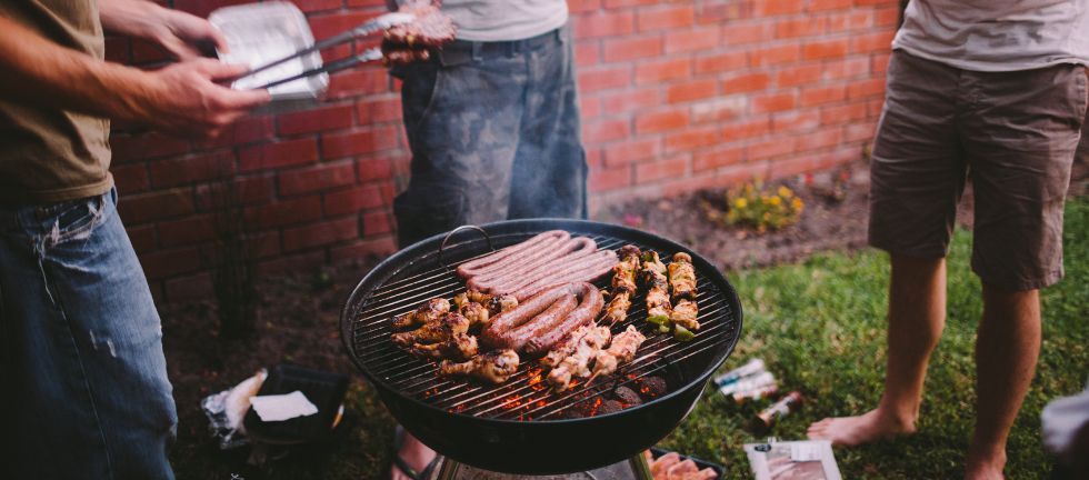 friends around the braai stand