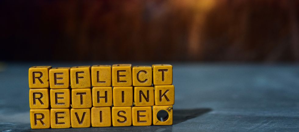 Letter tiles spelling out reflect rethink revise