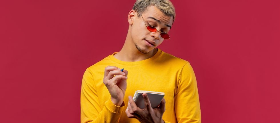 young adult man with pencil and notebook